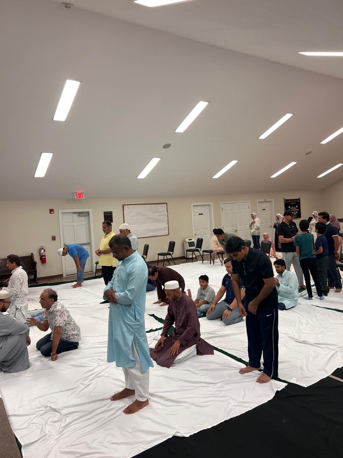 Worshippers praying together at the interim venue